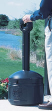 Load image into Gallery viewer, Person holding a black compost bin with 'Sunflower' branding outdoors.